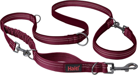 A green Halti dog leash with a double-ended design and a bungee element, featuring a clip at each end and neoprene padding.