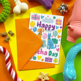 Colorful card with 'Happy Birthday' text and dog illustrations on a multicolored background with toys.