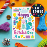 Colorful 'Happy Gotcha Day' card with dog illustrations surrounded by dog toys on a multicolored background.