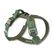 Green and brown patterned dog harness on a white background