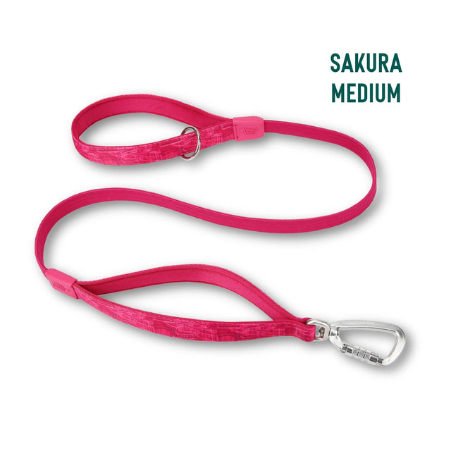 A bright pink dog leash with a silver carabiner clip, shown on a white background with the text 'SAKURA MEDIUM' in the top right corner.
