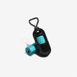 A black Zee.Dog poop bag dispenser with a blue opening, attached to a rope with a magnetic clasp, alongside a roll of poop bags.
